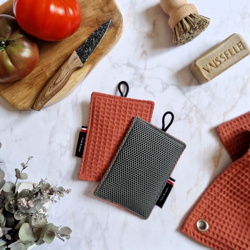 Une éponge pour laver sans rayer vaisselle, casseroles et plan de travail dans un joli tissu en nid d'abeille ton brique